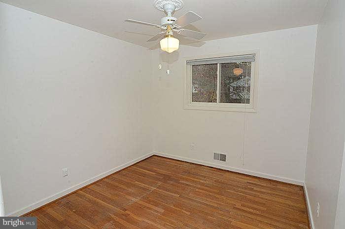 12514 Littleton Street Silver Spring, MD 20906 - Photo 11 of 29 wooden floor in an empty room with a window