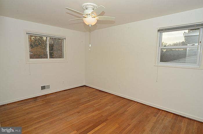 12514 Littleton Street Silver Spring, MD 20906 - Photo 12 of 29 a view of an empty room with a window and wooden floor