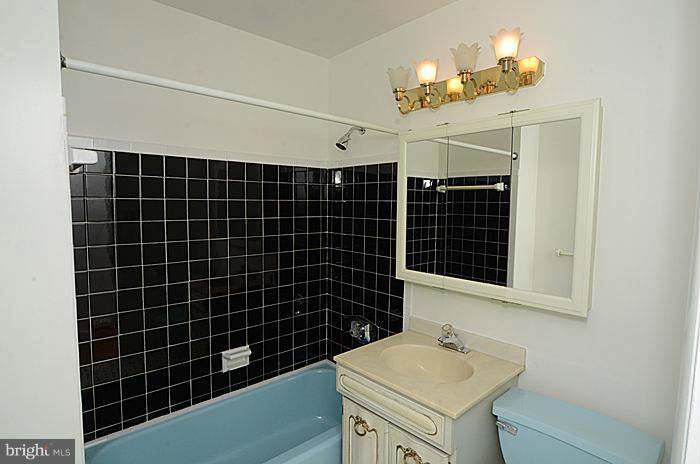 12514 Littleton Street Silver Spring, MD 20906 - Photo 13 of 29 a bathroom with a sink toilet shower and a mirror
