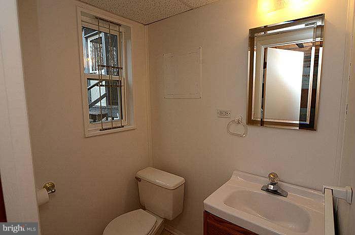 12514 Littleton Street Silver Spring, MD 20906 - Photo 17 of 29 a bathroom with a toilet sink and mirror