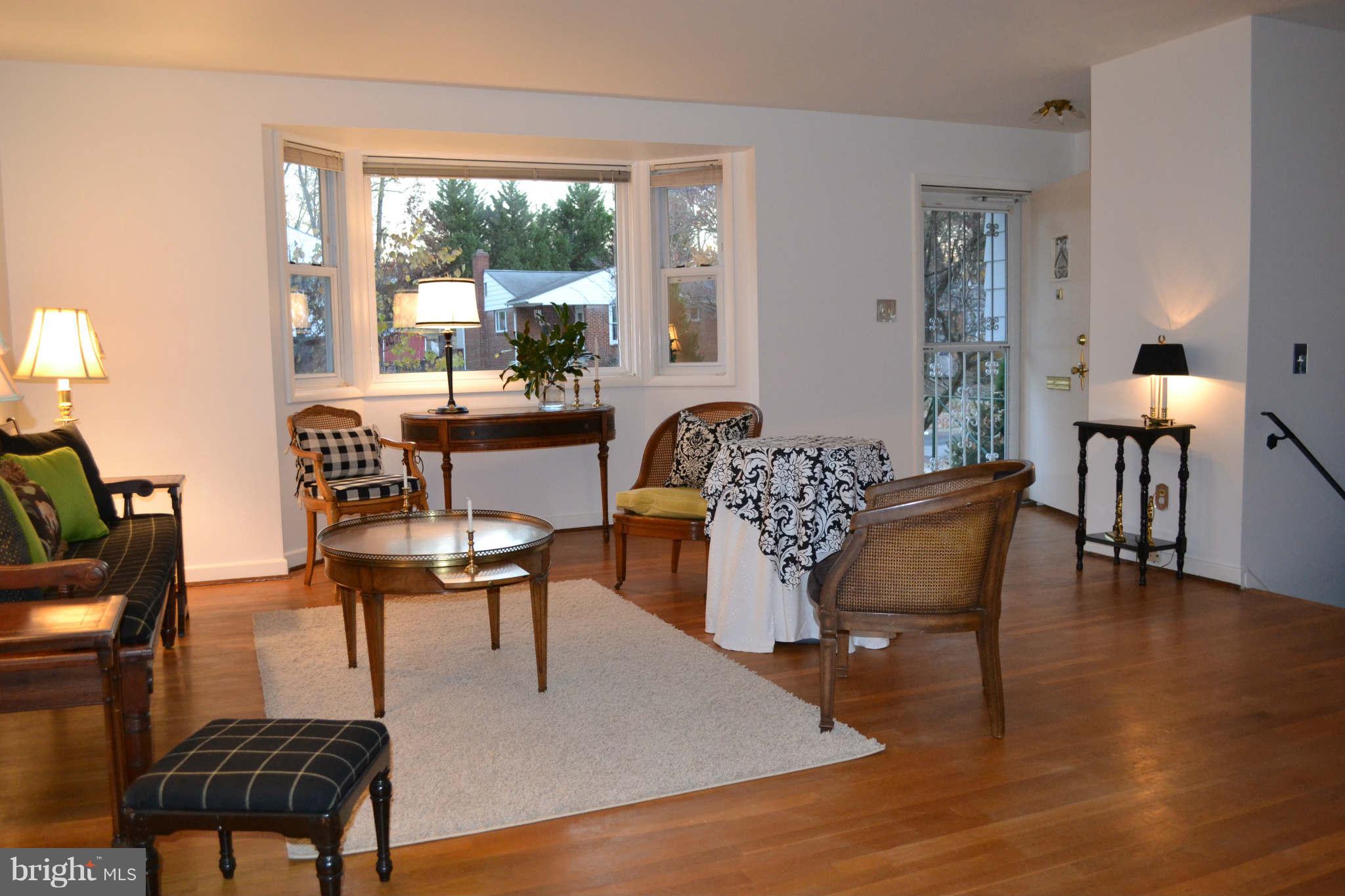 12514 Littleton Street Silver Spring, MD 20906 - Photo 5 of 29 a dining room with furniture a chandelier and wooden floor