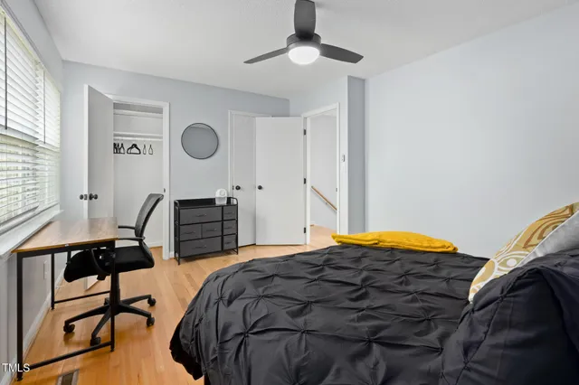 a bedroom with a bed a desk and chair