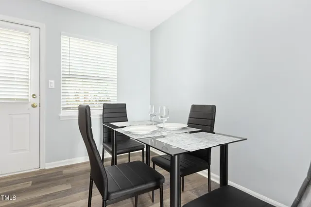 a view of a dining room with a table and chairs