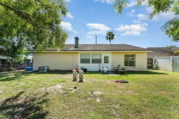 a backyard of a house with table and chairs