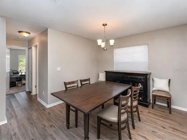 a view of a dining room with furniture and wooden floor