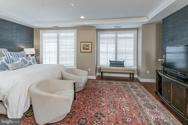 a spacious bedroom with a bed and a couch