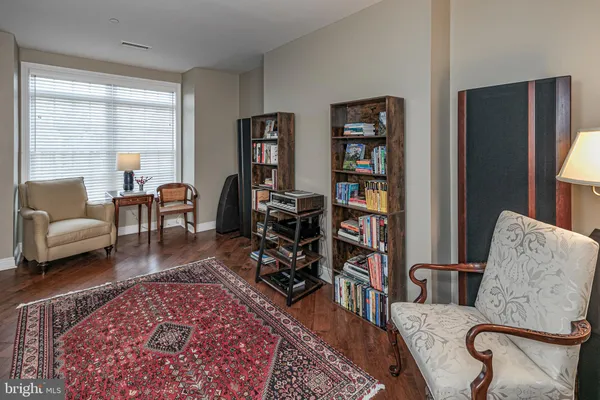 a living room with furniture and a book shelf