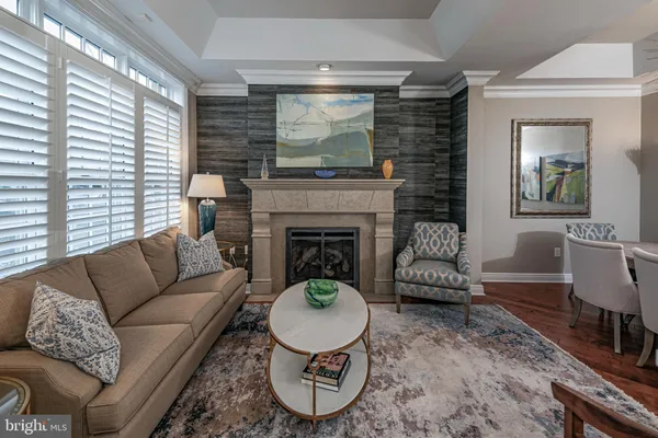 a living room with furniture a window and a fireplace