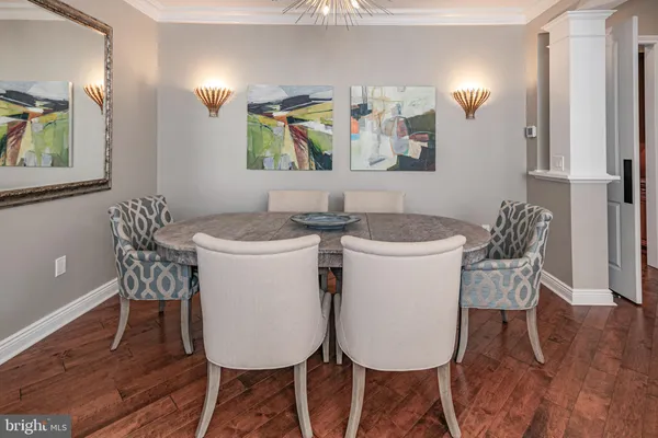 a dining room with furniture and wooden floor