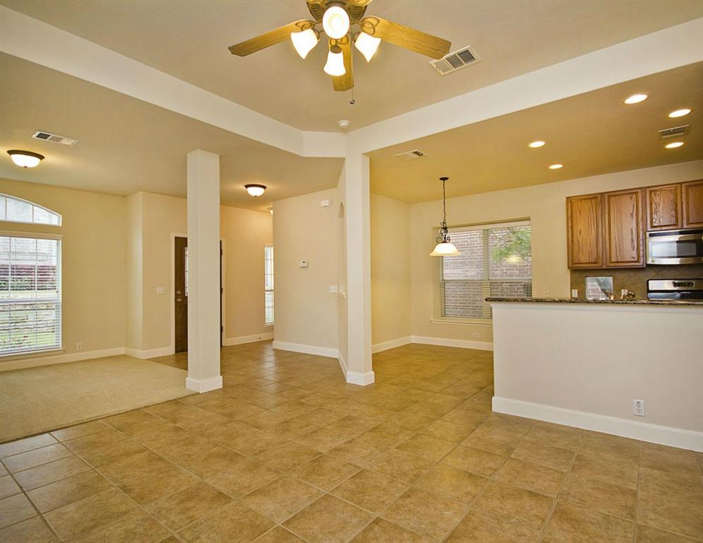 14812 Avery Ranch Boulevard, Unit 16 Austin, TX 78717 - Photo 11 of 32 a view of a kitchen with a refrigerator and a stove top oven