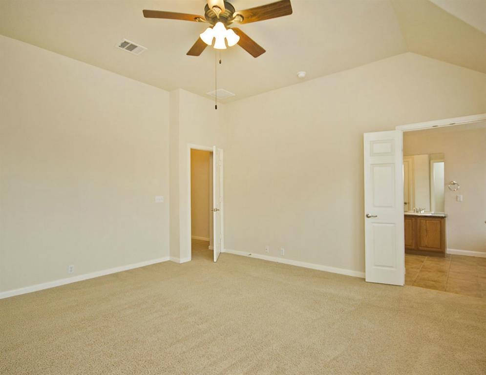 14812 Avery Ranch Boulevard, Unit 16 Austin, TX 78717 - Photo 20 of 32 an empty room with a ceiling fan and carpet