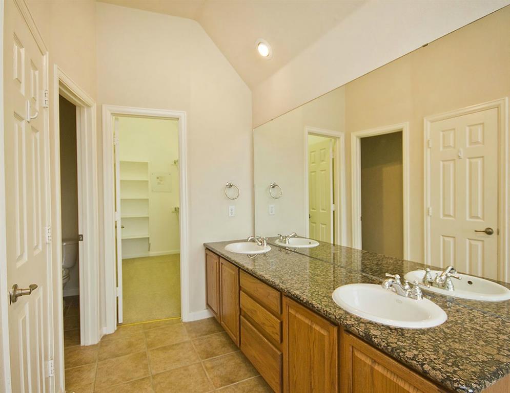 14812 Avery Ranch Boulevard, Unit 16 Austin, TX 78717 - Photo 21 of 32 a bathroom with a granite countertop sink and a mirror