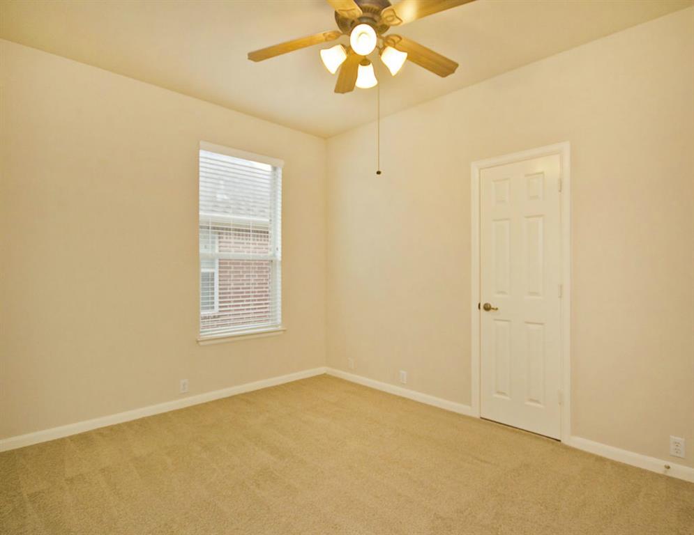 14812 Avery Ranch Boulevard, Unit 16 Austin, TX 78717 - Photo 29 of 32 an empty room with a window and a chandelier fan