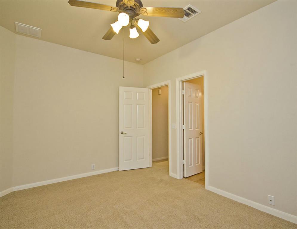 14812 Avery Ranch Boulevard, Unit 16 Austin, TX 78717 - Photo 30 of 32 an empty room with a chandelier fan and closet area