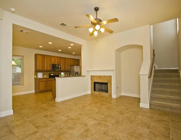 a view of a kitchen with a sink and a fireplace