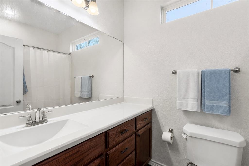 3309 South 3rd Street Waco, TX 76706 - Photo 13 of 31 a bathroom with a sink a toilet and shower