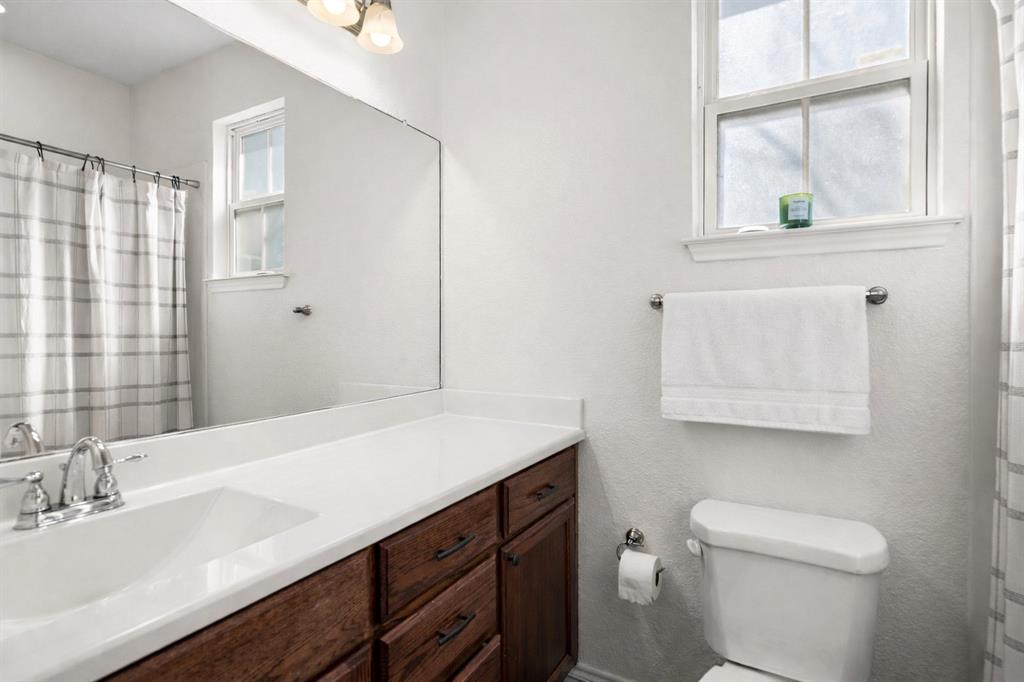 3309 South 3rd Street Waco, TX 76706 - Photo 14 of 31 a bathroom with a sink a toilet and a mirror