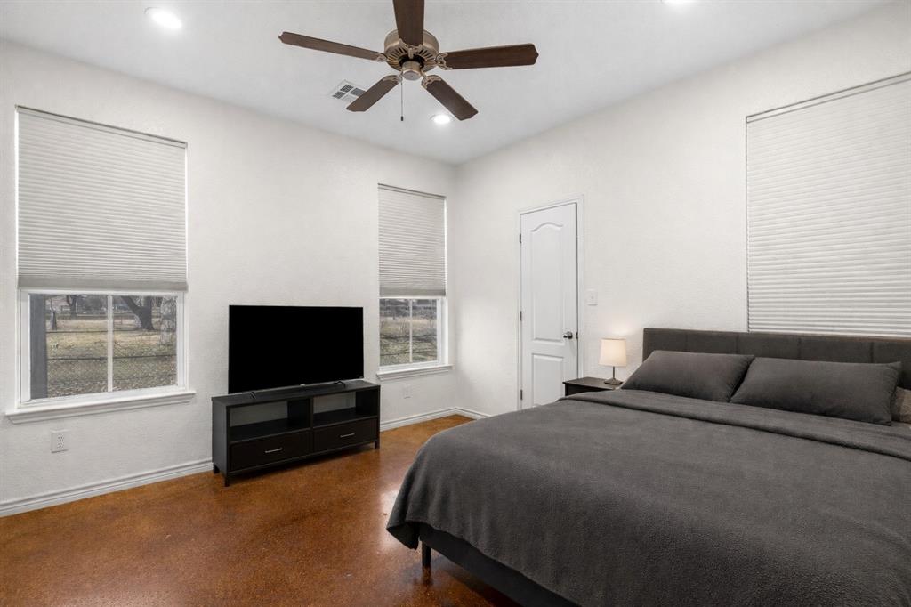 3309 South 3rd Street Waco, TX 76706 - Photo 16 of 31 a bedroom with a bed and a flat screen tv