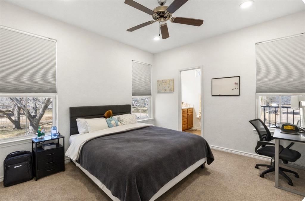 3309 South 3rd Street Waco, TX 76706 - Photo 18 of 31 a bedroom with a bed and a chandelier