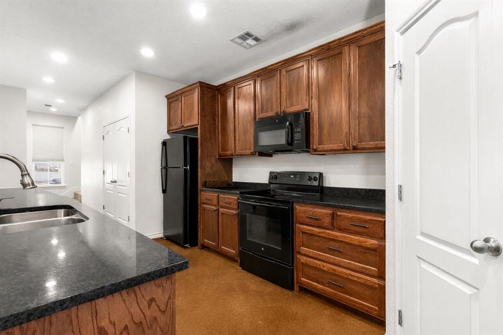 3309 South 3rd Street Waco, TX 76706 - Photo 10 of 31 a kitchen with stainless steel appliances granite countertop a stove a sink and a microwave