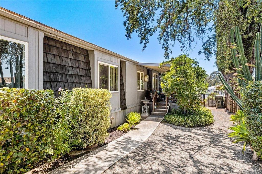18218 Paradise Mountain Road, Unit 116 Valley Center, CA 92082 - Photo 25 of 35 a front view of a house with garden