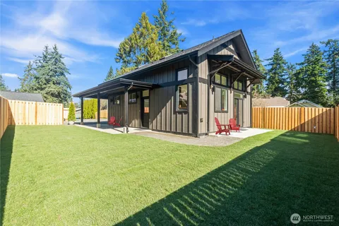 a view of a house with backyard and porch
