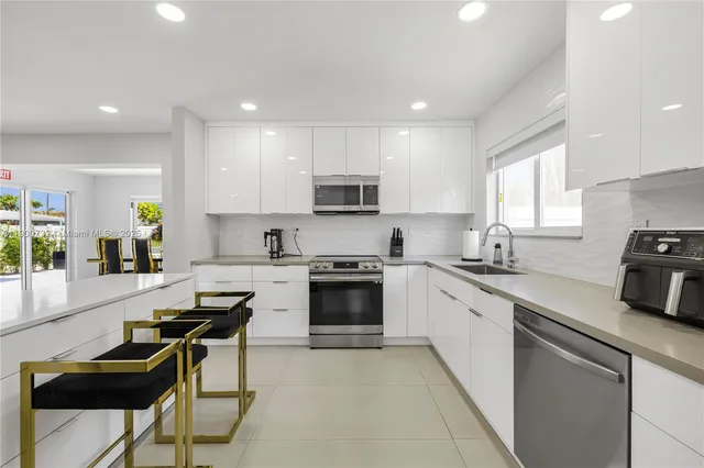 a kitchen with a stove a sink and a refrigerator