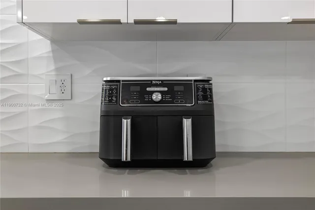 a view of backyard with potted plants and palm trees