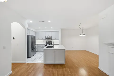 a kitchen with stainless steel appliances a refrigerator and a stove top oven
