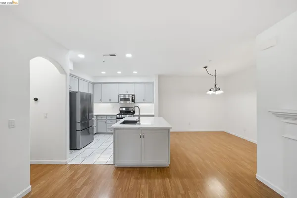 a kitchen with stainless steel appliances a refrigerator and a stove top oven