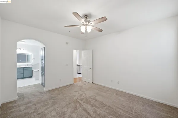 an empty room with closet and windows