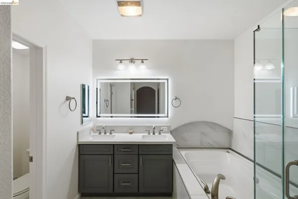 a bathroom with a sink vanity and mirror