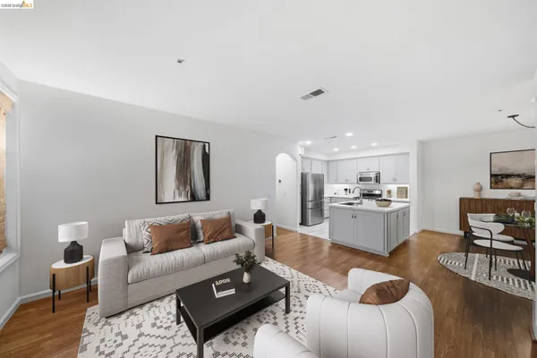 a living room with furniture and kitchen view