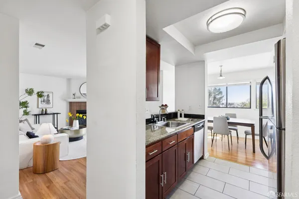 a kitchen with stainless steel appliances granite countertop a stove a sink and a refrigerator