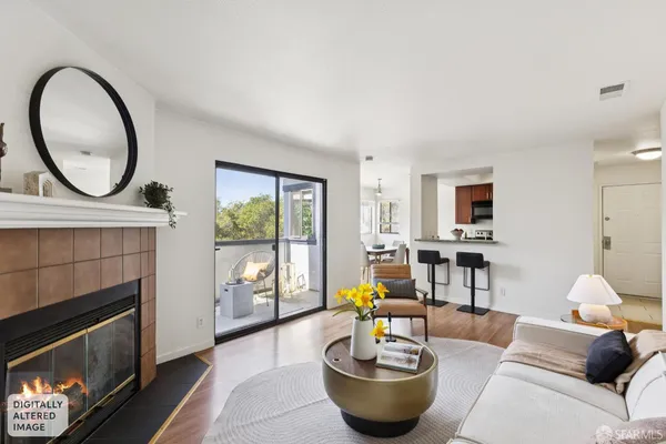 a view of a hallway with wooden floor and a living room