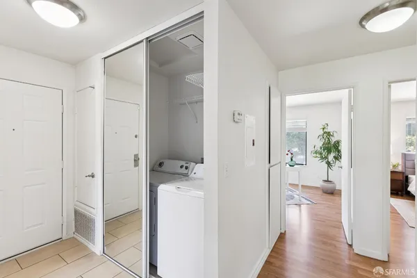 a living room with furniture potted plant and a large window