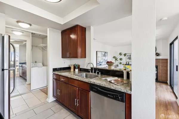 a kitchen with granite countertop a sink and cabinets