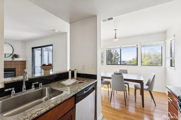 a kitchen with stainless steel appliances granite countertop a sink and a stove