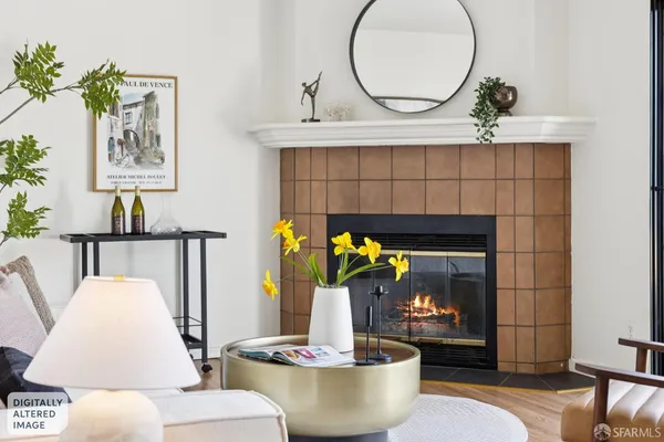 a living room with furniture a window and a fireplace