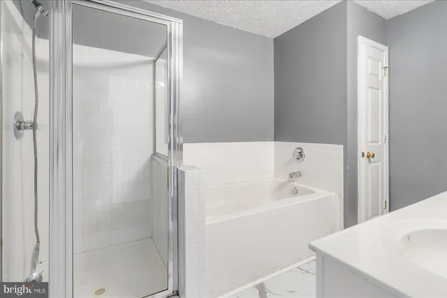 a white bath tub sitting next to a white sink