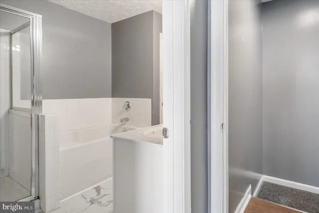 a white bath tub sitting next to a white sink