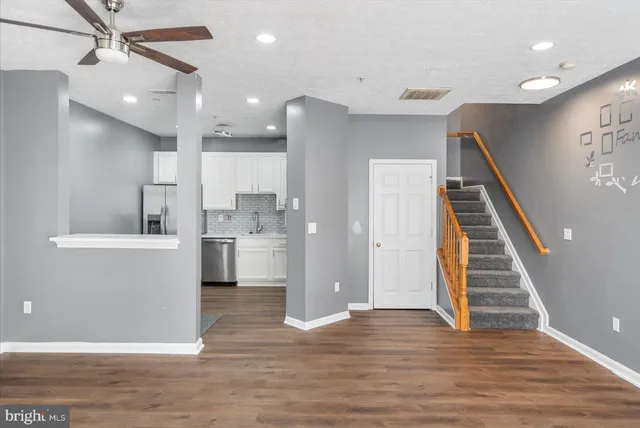 a view of a kitchen with wooden floor and electronic appliances