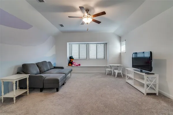 a bedroom with a bed dresser and a window