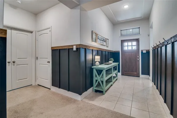an entryway with a door and fire place