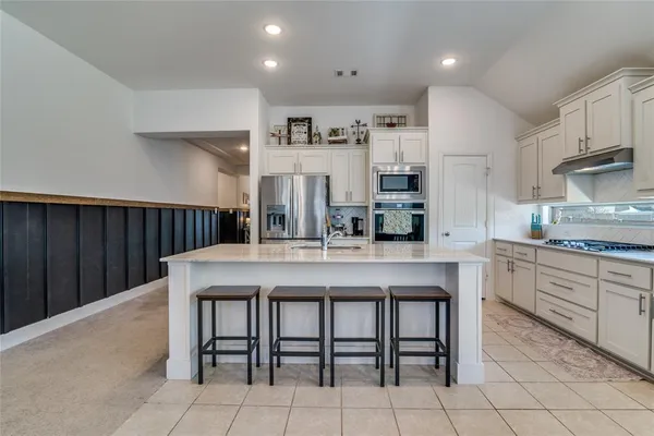 a kitchen with counter top space and living room