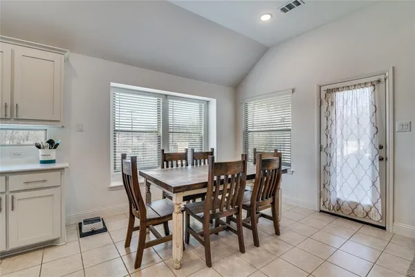 a kitchen with white cabinets and appliances