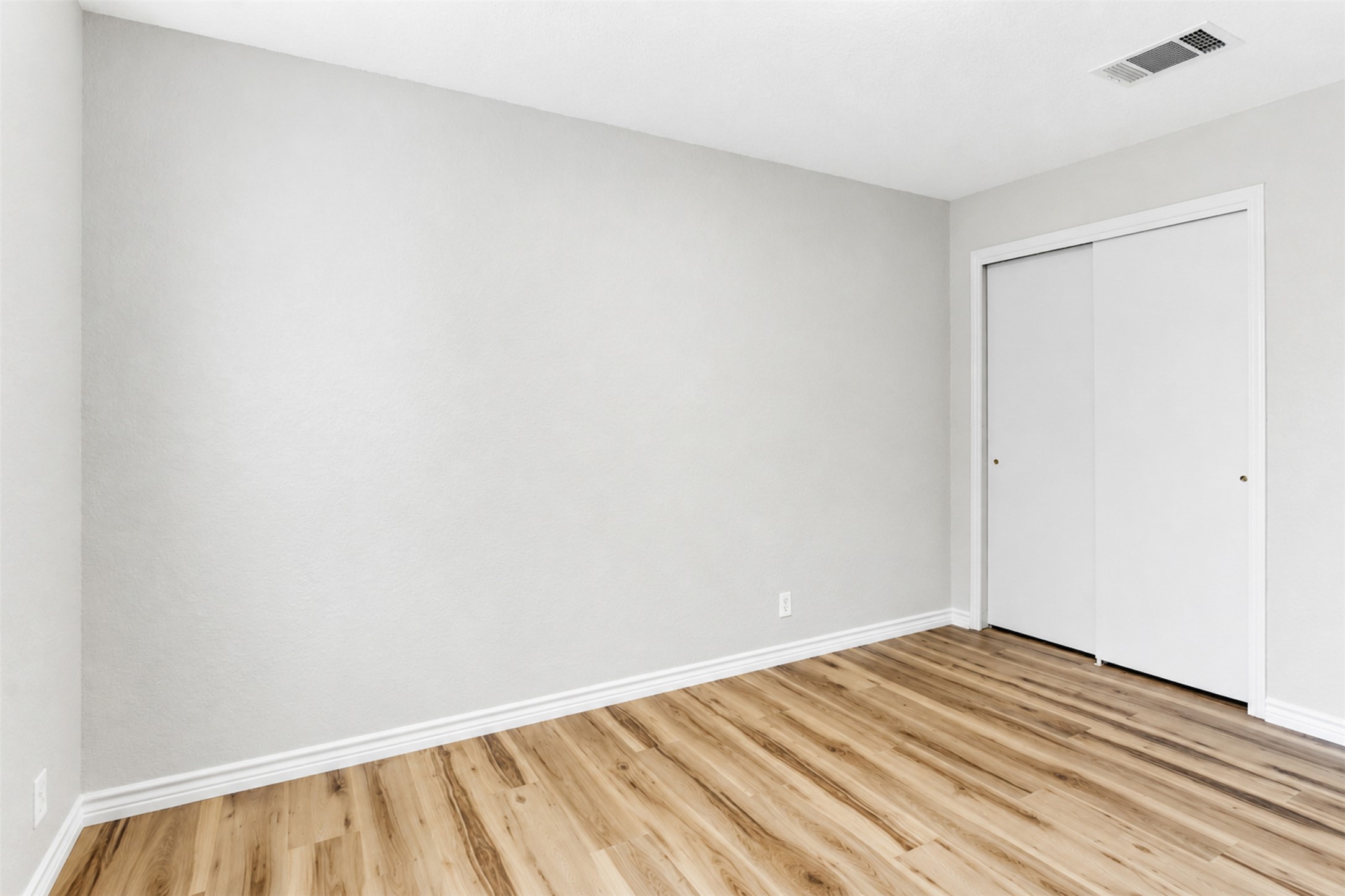 4523 Secure Lane Austin, TX 78725 - Photo 33 of 40 Laminate flooring and a functional closet define this serene sleeping space.