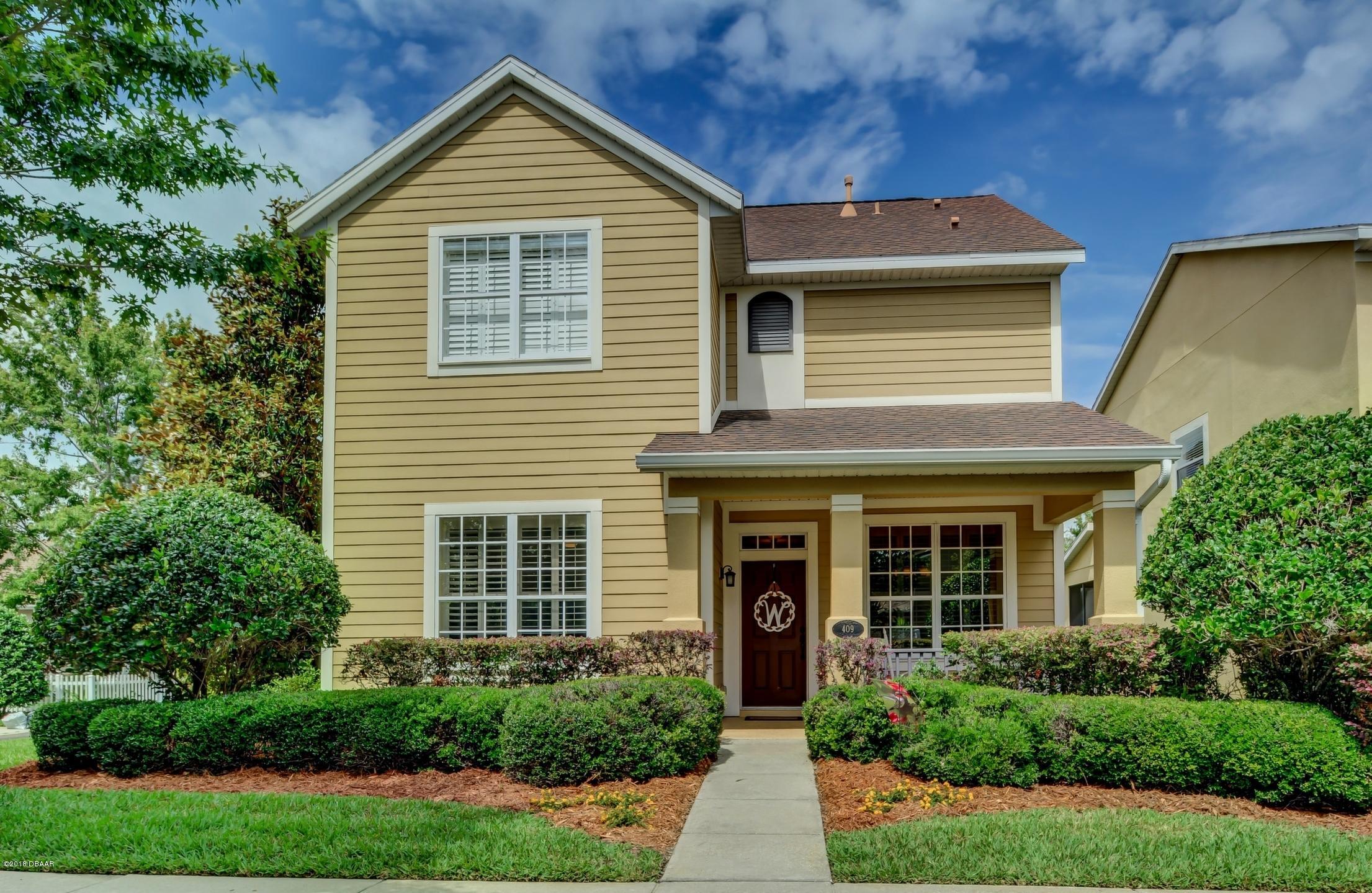 409 Manor View Lane DeLand, FL 32724 - Photo 1 of 31 a front view of a house with plants and garden