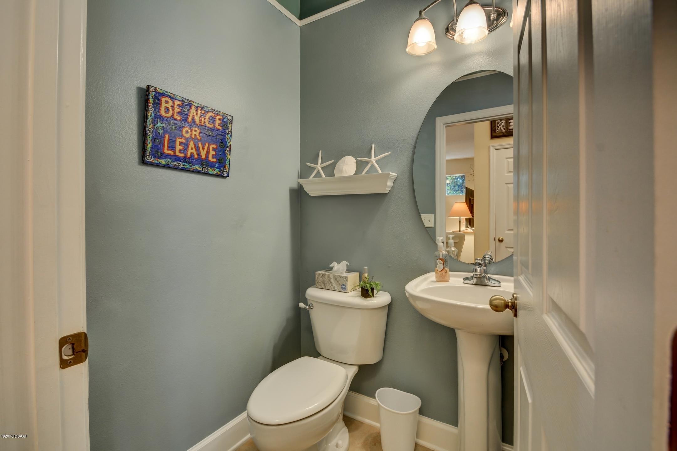 409 Manor View Lane DeLand, FL 32724 - Photo 17 of 31 a white toilet sitting next to a bathroom sink