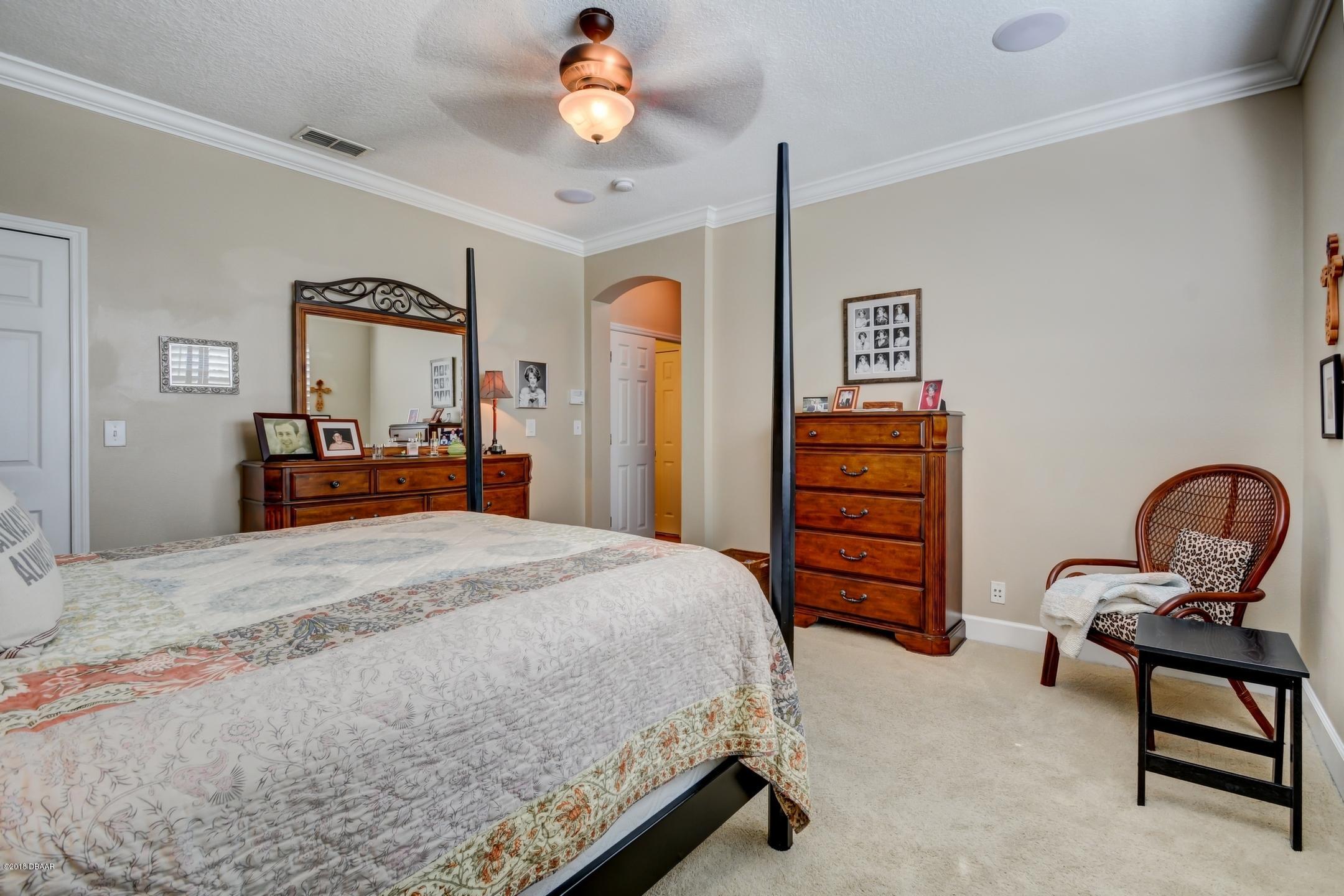 409 Manor View Lane DeLand, FL 32724 - Photo 19 of 31 a bedroom with a bed and furniture